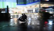 Motorists speed past a deserted street and shopping mall as Typhoon Mangkhut approaches the city of Tuguegarao, Cagayan province, north of Manila on September 14, 2018.  AFP / Ted Aljibe 