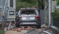 A car is destroyed from falling bricks as Hurricane Florence passes over Wilmington, North Carolina on September 14, 2018. AFP / Andrew Caballero-Reynolds
 