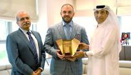 Senior Deputy Group President & CEO of QIC Group,  Ali AlFadala (right), presenting a memento to Ambassador of Romania Cristian Tudor (centre).