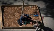 Two homeless men on the pavement in Paris on September 14, 2018. AFP / Joel Saget 