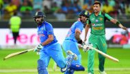 Indian cricket team captain Rohit Sharma (L) and his teammate Shikhar Dhawan (C) run between the wickets during the one day international (ODI) Asia Cup cricket match between Pakistan and India at the Dubai International Cricket Stadium in Dubai on Septem