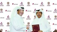 Qatar Chamber Director-General Saleh bin Hamad Al Sharqi (right) and Manateq’s CEO Fahad Rashid Al Kaabi shake hands after signing the sponsorship agreement at Qatar Chamber headquarters.