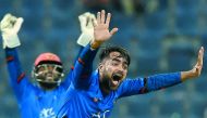 Afghan cricketer Rashid Khan (R) appeals for an unsuccessful leg before wicket (LBW) decision against unseen Bangladesh batsman Mosaddek Hossain during the one day international (ODI) Asia Cup cricket match between Bangladesh and Afghanistan at The Sheikh