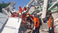 A search and rescue team evacuates a victim from the ruins of the Roa-Roa Hotel in Palu, Central Sulawesi, Indonesia September 30, 2018 in this photo taken by Antara Foto. Antara Foto/BNPB/ via REUTERS 