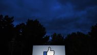 A lit Like sign is seen at the entrance to Facebook corporate headquarters location in Menlo Park, California on March 21, 2018. AFP/Josh Edelson