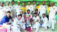 Warriors Club’s players pose with the trophy after winning the Division A final of QCA Twenty20 Cricket Tournament played in Doha recently.