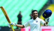 Prithvi Shaw celebrates after scoring a century (100 runs) during the first of the first Test cricket match between India and West Indies at the Saurashtra Cricket Association stadium in Rajkot on October 4, 2018. AFP / Indranil Mukherjee 