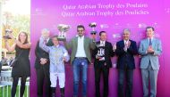 H E Sheikh Joaan bin Hamad Al Thani, President of Qatar Olympic Committee poses for a group picture after races at St Cloud, France yesterday.