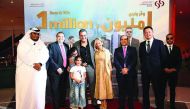 Joseph Abraham (third right), Commercial Bank CEO; Amit Sah (second left), Head of Retail Banking at Commercial Bank, and other bank officials with Raymond Frangieh, grand prize winner of Commercial Bank’s Save & Win campaign, and family. 
