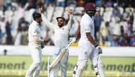 Indian captain Virat Kohli (C) and bowler Umesh Yadav celebrate the dismissal of West Indies batsman Shannon Gabriel (R) during the third day's play of the second Test cricket match between India and West Indies at the Rajiv Gandhi International Cricket S