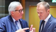 European Commission President Jean-Claude Juncker (L) and European Council President Donald Tusk greet each others at the start of a tripartite social summit at the European Council in Brussels on October 16, 2018. AFP/Emmanuel Dunand 