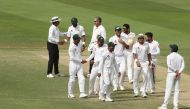 Pakistan cricketers celebrate at the end of day four of the second Test cricket match between Australia and Pakistan at Sheikh Zayed stadium in Abu Dhabi on October 19, 2018. (AFP / KARIM SAHIB)