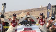 Qatari driver Nasser Saleh Al Attiyah (right) and his navigator Matthieu Baumel celebrate after winning an earlier stage of the  FIA Middle East Rally Championship  in Jordan in this file photo. 