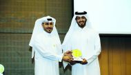 Hilal Saad Al Mohannadi (right), Head of Environment Regulatory and Compliance at Qatargas, receiving the award from Meshal Al Shamari, Director of Qatar Green Building Council.