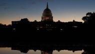 The US Capitol is reflected in a puddle of water a day after Americans voted in the midterm elections, on November 7 2018 in Washington. Mark Wilson/Getty Images/AFP