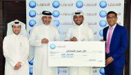 D Anand (right), QIB’s Personal Banking Group General Manager, with the grand prize winner, Ali Al Mslmani. 