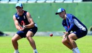 England's captain Joe Root (R) takes a catch as Jos Buttler looks on during a practice session at the Sinhalese Sports Club (SSC) Ground in Colombo on November 21, 2018.  AFP / Ishara S Kodikara

