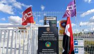 Union flags are pictured outside Amazon facilities in San Fernando de Henares, the biggest in Spain, during a strike on November 23, 2018.  AFP / Oscar Del Pozo 