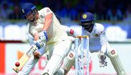 England's Jonny Bairstow (L) plays a shot as Sri Lanka's wicketkeeper Niroshan Dickwella (R) looks on during the first day of the third Test match between Sri Lanka and England at the Sinhalese Sports Club (SSC) international cricket stadium in Colombo on