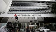 A TV cameraman stands in front of Mitsubishi Motors Corp's headquarters in Tokyo, Japan November 26, 2018. REUTERS/Toru Hanai