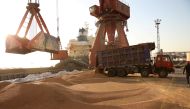 Workers transport imported soybeans at a port in Nantong, Jiangsu province, China April 9, 2018. Reuters