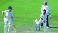 Pakistani spinner Yasir Shah (R) delivers the ball as New Zealand captain Kane Williamson (L) looks on during the first day of the third and final Test cricket match between Pakistan and New Zealand at the Sheikh Zayed International Cricket Stadium in Abu