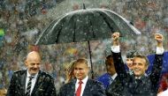 FIFA president Gianni Infantino, President of Russia Vladimir Putin and President of France Emmanuel Macron stand during the presentation during the World Cup at the Luzhniki Stadium in Moscow, Russia, July 15, 2018. Reuters/Kai Pfaffenbach