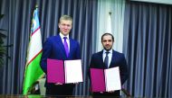 QEF Secretary General Badr Mohammed Al Darwish (right) and MPFU President Bakromjon Gaziev pose for a picture after the signing ceremony. 