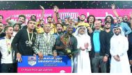 Qatar University’s players and officials celebrate with the trophy after winning the final.