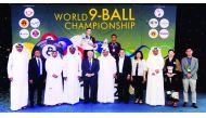 The champion, Joshua Filler (rear, centre) and runner-up Carlo Biado, pose for a photograph with the officials of Qatar Billiard and Snooker Federation and World Pool Billiard Association at the conclusion  of the 2018 World 9-Ball Championship at the Al 