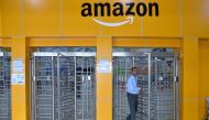FILE PHOTO: An employee of Amazon India walks out of a security gate at Amazon's newly launched fulfilment centre on the outskirts of Bangalore. AFP / MANJUNATH KIRAN