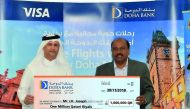 Lucky winner J K Joseph receiving the cheque from Doha Bank official. 
