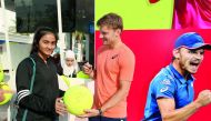 A tennis fan gets an autograph from one of her favourite stars at the Qatar ExxonMobil Open Public Village Stand.