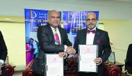 Dr. R Seetharaman (right), CEO of Doha Bank, and a StockHolding official during the signing ceremony.