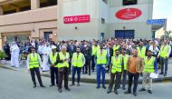 QIIB staff and  Civil Defense and Emergency Medical Service personnel seen assembled in front of QIIB building on Grand Hamad Street.
