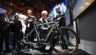 An attendee touches the batteries of a Van Dessel electric gravel bike, at the Panasonic booth at CES 2019 consumer electronics show, January 10, 2019 at the Las Vegas Convention Center in Las Vegas, Nevada. AFP / Robyn Beck 