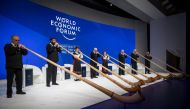 Alphorn blowers perform during the opening of the World Economic Forum (WEF) annual meeting, on January 22, 2019 in Davos, eastern Switzerland. / AFP / Fabrice COFFRINI