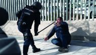 Police officer uses his baton on a striking taxi driver during a taxi strike against regulation of ride-hailing and car-sharing services such as Uber and Cabify in Madrid, Spain, January 24, 2019. Reuters/Susana Vera