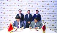 H E Ali bin Ahmed Al Kuwari (standing at the centre), Minister of Commerce and Industry, and Sheikh Khalifa bin Jassim Al Thani (standing right),Qatar Chamber Chairman, witnessing the signing of an agreement the sidelines of the Qatar-China Business Forum