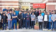Dr Abdulbasit Ahmad Al Shaibei, Chief Executive Officer of QIIB, and other senior executives and employees of the Bank posing for a group picture while participating at this year’s National Sport Day yesterday.