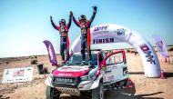 Qatar’s Nasser Saleh Al Attiyah and his navigator Matthieu Baumel celebrate after winning the Manateq Qatar Cross-Country Rally, the opening round of the FIA World Cup for Cross-Country Rallies, yesterday.
