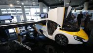 People look at the AeroMobil flying car during its unveiling at the Top Marques Monaco supercar show in Monaco April 20, 2017. Reuters/Jean-Paul Pelissier