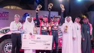 Qatar Motor and Motorcycle Federation President Abdulrahman Al Mannai, Manateq CEO Fahad Al Kaabi and officials pose for a photograph with Al Attiyah and Matthieu Baumel during the presentation ceremony on Tuesday.