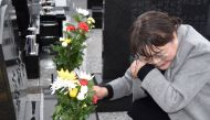 A woman pays her respects at a cemetery in Namie, Fukushima Prefecture on March 11, 2019 on the eighth anniversary of the 2011 tsunami disaster. Japan OUT / AFP / JIJI PRESS / JIJI PRESS
 