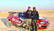 Qatar’s Nasser Saleh Al Attiyah and his French co-driver Matthieu Baumel pose for a photograph after a test run yesterday.