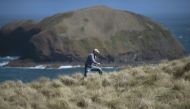 This photo taken on February 24, 2019 shows Mike Buckby from the Cape Grim Water Company walking in Cape Grim, Tasmania. Andrew BEATTY / AFP / William WEST