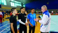 From left: Qatari gymnasts Raslan Saoud, Ahmed Mosa and Ahmed Al Dayani speak to their coach during a training session at Aspire Dome. 