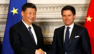 Italian Prime Minister Giuseppe Conte and Chinese President Xi Jinping shake hands after signing trade agreements at Villa Madama in Rome, Italy March 23, 2019. REUTERS/Yara Nardi