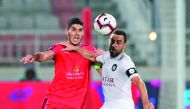Al Duhail’s Karim Boudiaf (left) vies for the ball possession with Al Sadd’s captain, Spanish legend Xavi Hernandez during their QNB Stars League match played at the Al Duhail Stadium yesterday. 