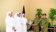 QIB Senior officials receiving a plaque from the Amiri Guard officer. 

